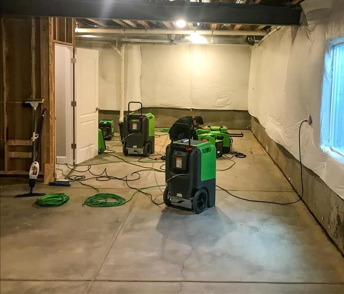 SERVPRO setting up equipment to clean up after a basement flood