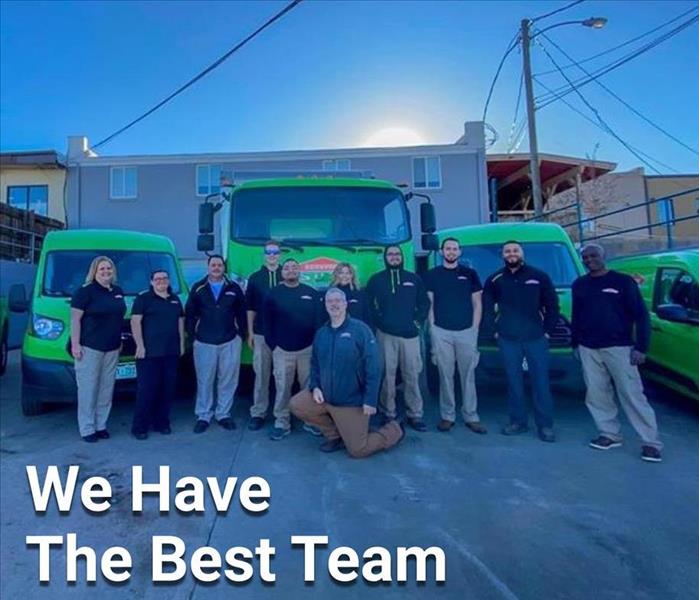 SERVPRO team of people in front of SERVPRO trucks
